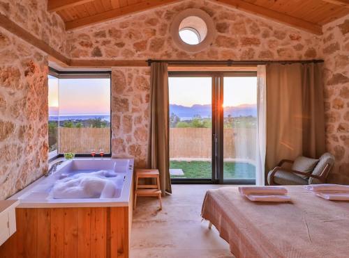 a large bathroom with a bath tub and a bed at Villa No11 Kaş Üzümlü Köyü in Kas