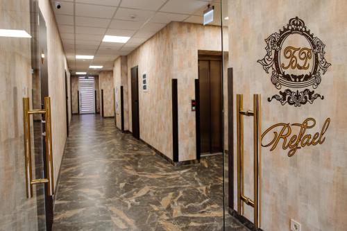 a hallway of a hotel with a sign on the wall at Hotel Boutique Refael in Truskavets