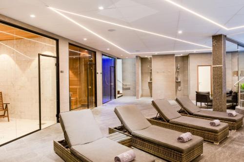 a lobby with chairs and a waiting room at AC Hotel by Marriott Stockholm Ulriksdal in Solna
