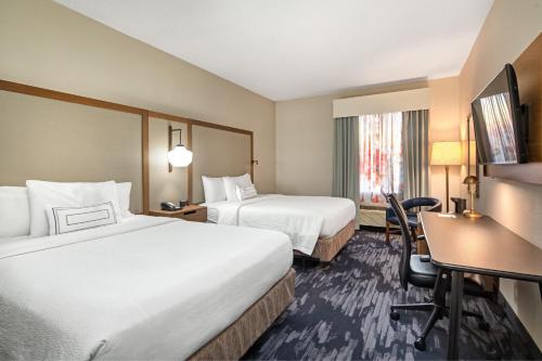 a hotel room with two beds and a desk at Fairfield Inn by Marriott Toronto Oakville in Oakville