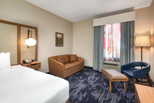 a hotel room with a bed and a chair at Fairfield Inn by Marriott Toronto Oakville in Oakville
