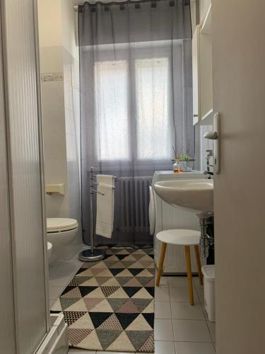 a bathroom with a sink and a toilet and a shower at Pinzolo DOLOMIA apartment in Pinzolo
