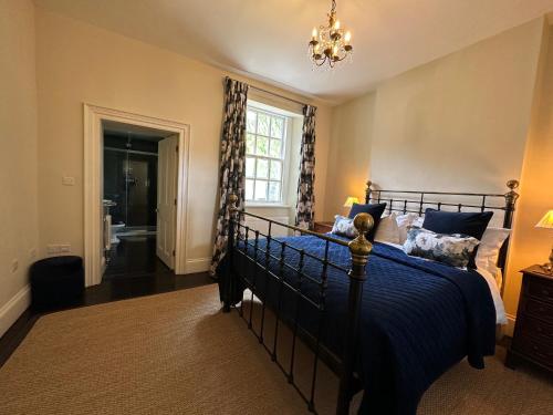 a bedroom with a bed with a blue comforter at Ann's Hill in Cockermouth