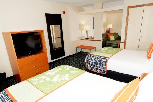 a hotel room with two beds and a flat screen tv at Fairfield Inn & Suites by Marriott Killeen in Killeen