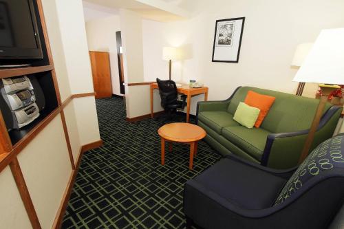 a hotel room with a couch and a chair at Fairfield Inn & Suites by Marriott Killeen in Killeen