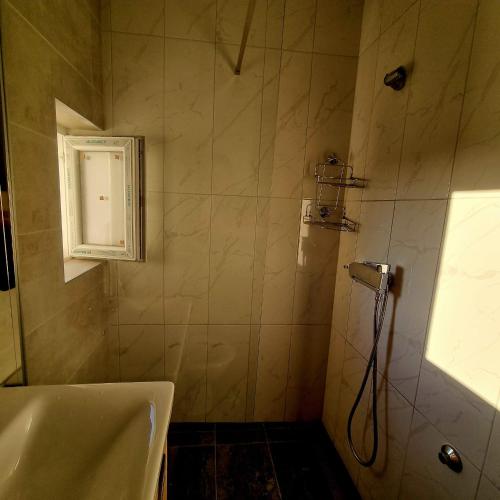 a bathroom with a shower and a sink at Apartmani Katarina in Biograd na Moru
