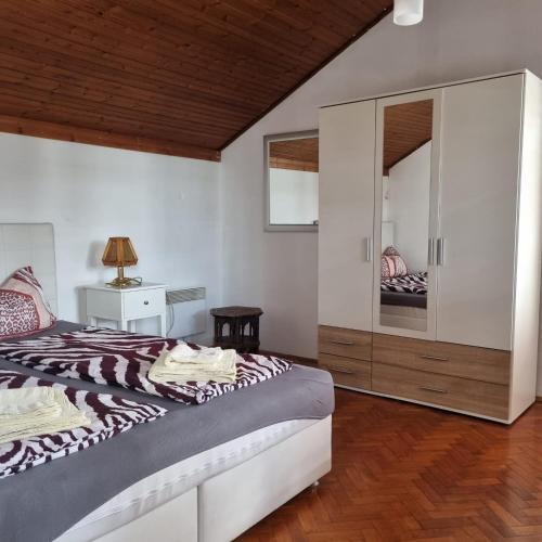 a bedroom with a bed and a large mirror at Apartmani Katarina in Biograd na Moru