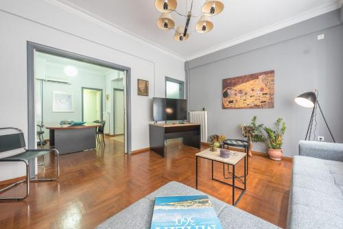 a living room with a couch and a table at Andromar in the heart of Kolonaki in Athens