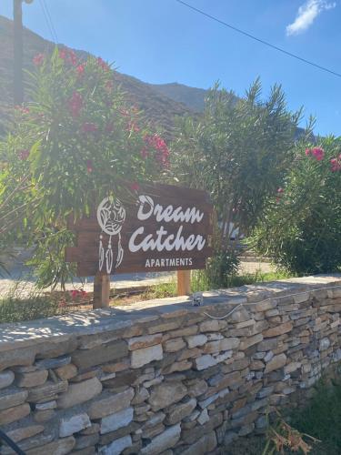 a sign for a dream catcherasylords sign over a stone wall at Dream Catcher3 in Agia Theodoti