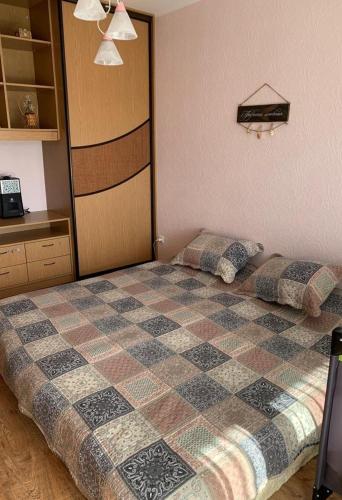 a bedroom with two beds and a checkered bedspread at Just chill in Rīga
