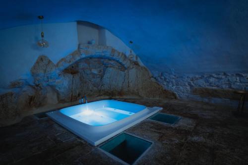 a bathroom with a bath tub in a blue room at Arquati Suite Luxury Apartment in Ostuni
