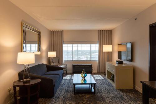 a living room with a couch and a table at Sheraton Chicago Northbrook in Northbrook