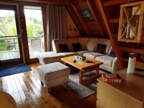 a living room with a couch and a table at Ferienhaus Brungers in Südbrookmerland