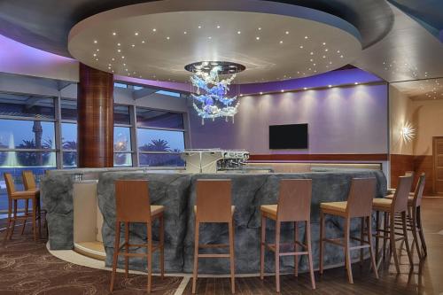 a bar in a hotel room with chairs around it at Four Points by Sheraton Oran in Oran