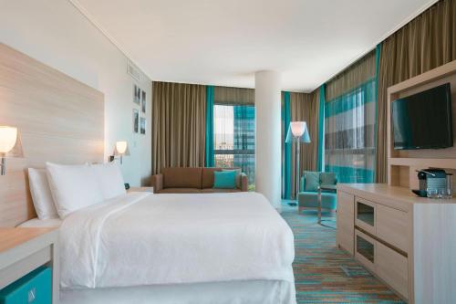 a hotel room with a bed and a television at Four Points by Sheraton Oran in Oran