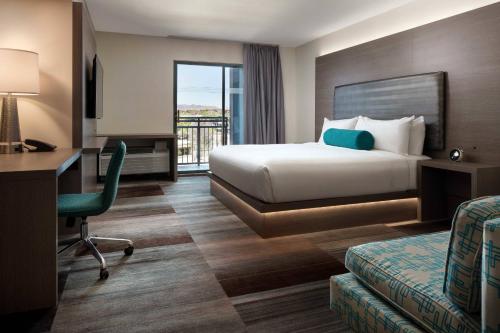 ein Hotelzimmer mit einem Bett und einem Schreibtisch in der Unterkunft Aloft Scottsdale in Scottsdale
