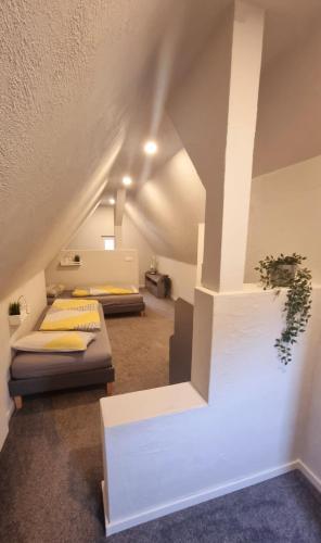 a room with two beds in a attic at Haus Erdmann in Dahn