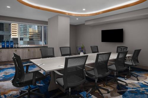 a conference room with a large table and chairs at Courtyard by Marriott Calgary Downtown in Calgary