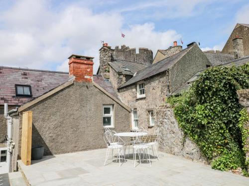 a patio with a table and chairs in front of a building at 10 Westgate Hill in Pembroke