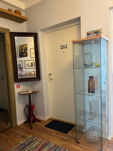 a room with a glass shelf next to a door at Sveriges minsta Hotell! Hôtel Gruyère in Landskrona