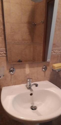 a white sink in a bathroom with a mirror at ЖК Sunshine&lov Апартамент Релакс in Kranevo