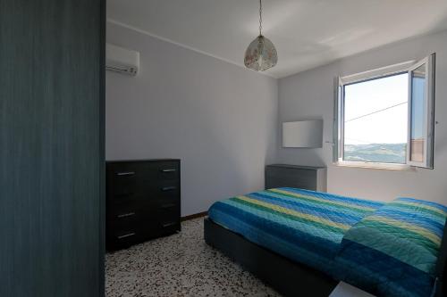 a bedroom with a bed and a window at La Casetta di Filomena in Lama Di Peligni