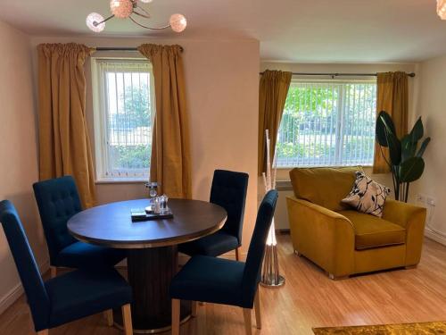 a living room with a table and a couch at Modern Spacious Gated Two Bedrooms Apartment in Stifford