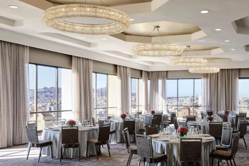 a dining room with tables and chairs and windows at San Francisco Marriott Union Square in San Francisco