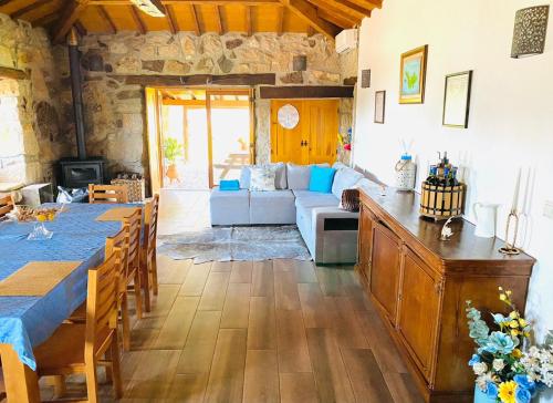 a living room with a table and a couch at Quinta do Mirante in Celorico de Basto
