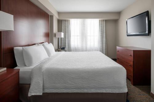 a hotel room with a bed and a television at Residence Inn Long Beach Downtown in Long Beach