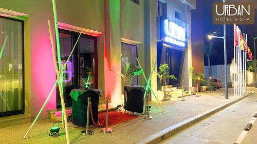 a building with colorful walls and plants on a sidewalk at Urban Hotel & Spa in Kenitra
