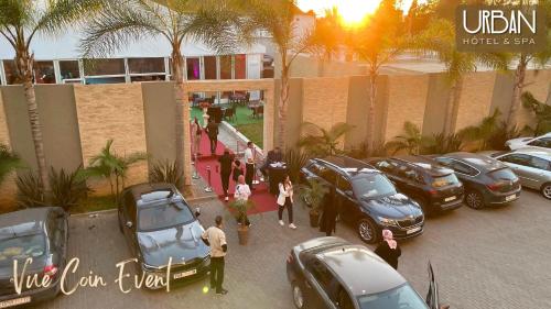 a group of people standing in a parking lot with cars at Urban Hotel & Spa in Kenitra