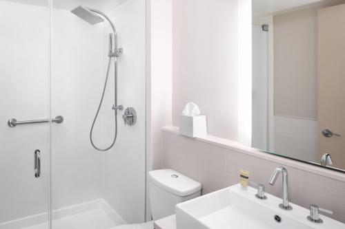 a bathroom with a shower and a toilet and a sink at Element Times Square West in New York