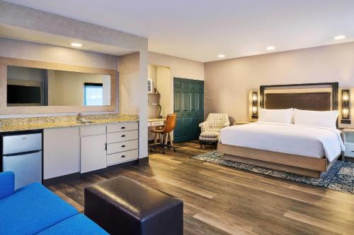 a hotel room with a bed and a desk at Four Points by Sheraton Salt Lake City Airport in Salt Lake City