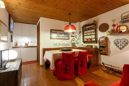 una stanza con tavolo e sedie rosse di Maison Courmayeur a Verrand