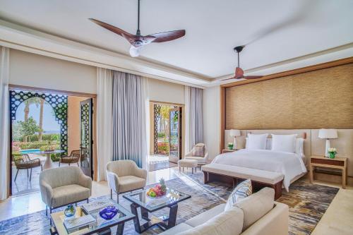 a bedroom with a bed and a living room at Four Seasons Resort Sharm El Sheikh in Sharm El Sheikh