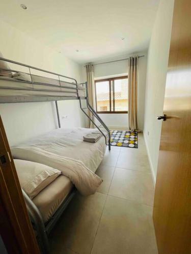 a bedroom with two bunk beds and a window at Attic apartment in old town in Denia