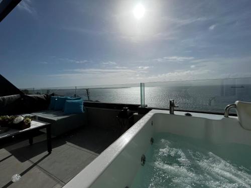 a bath tub with a view of the ocean at Mavi Panorama Villa in Cesme