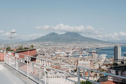 a view of a city with a mountain in the background at Vista Napoli Residence by Casa Napoletana in Naples