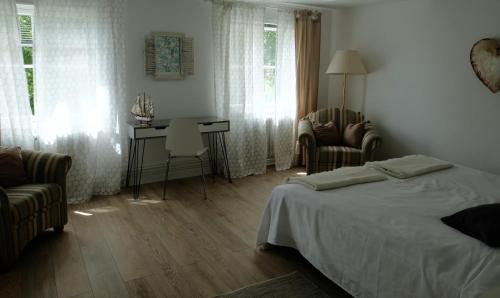 Schlafzimmer mit einem Bett, einem Tisch und Stühlen in der Unterkunft Altes Zollamt - Sünnschien - [#40126] in Kellenhusen