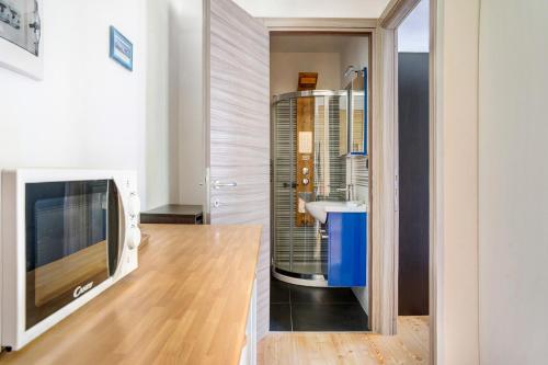 a bathroom with a sink and a tv in a room at Alta Valle Maira B in Acceglio
