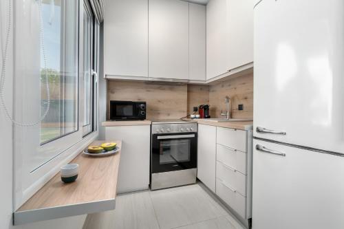 a small kitchen with white cabinets and a window at Utopia Eco Retreat in Skiathos Town