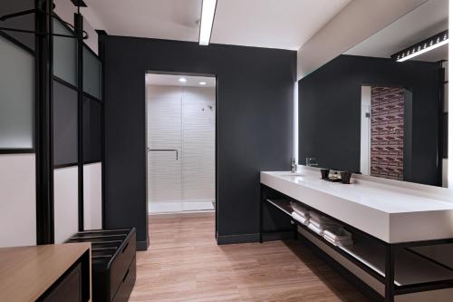 a bathroom with a white sink and a mirror at Aloft San Antonio UTSA Area in San Antonio