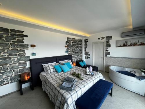 a bedroom with a bed and a bath tub in a room at Mavi Panorama Villa in Cesme