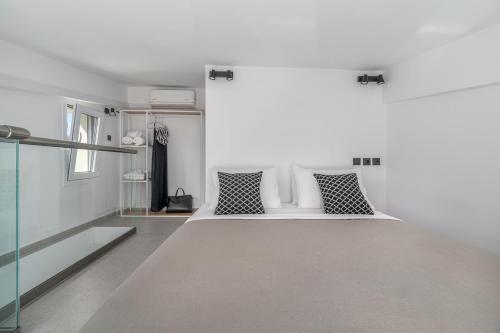 a bedroom with a bed with two pillows at Utopia Eco Retreat in Skiathos Town