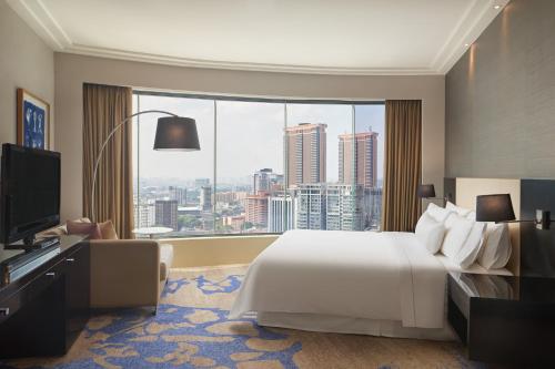 a hotel room with a large bed and a large window at The Westin Kuala Lumpur in Kuala Lumpur