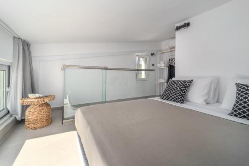a bedroom with a large bed and a window at Utopia Eco Retreat in Skiathos Town