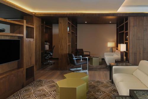 a living room with a couch and a tv at JW Marriott Hotel Santo Domingo in Santo Domingo