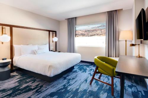 a hotel room with a bed and a desk and a chair at Fairfield Inn & Suites by Marriott Tijuana in Tijuana