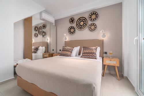 a bedroom with a large bed with plates on the wall at Utopia Eco Retreat in Skiathos Town